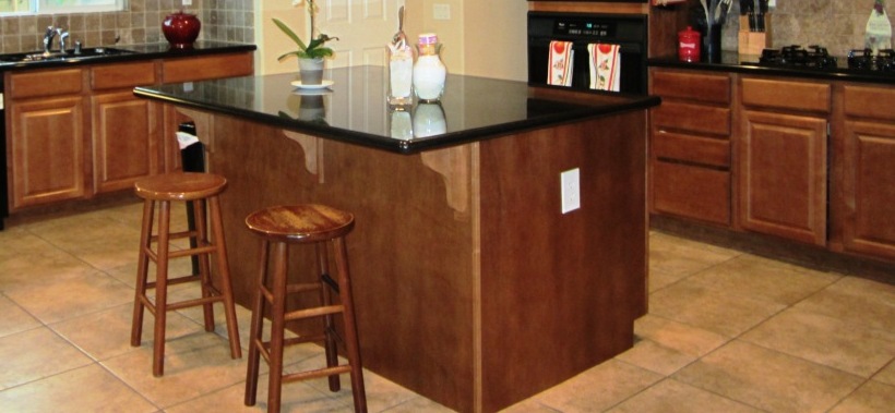 Then: rounded edges of granite countertops with square tiled flooring.